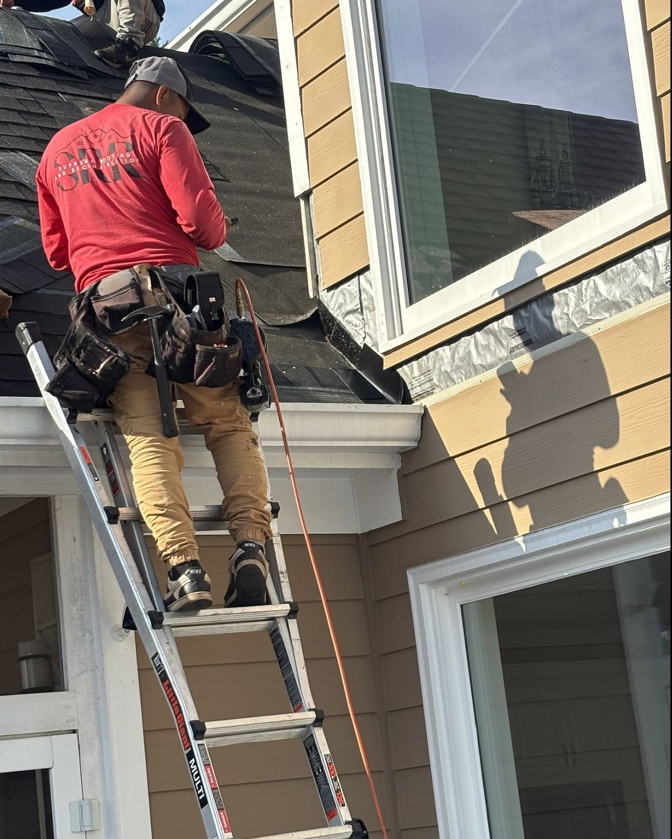 Supreme Roofing crew installing gutters in Oconee County, GA — seamless gutter installation completed in one day