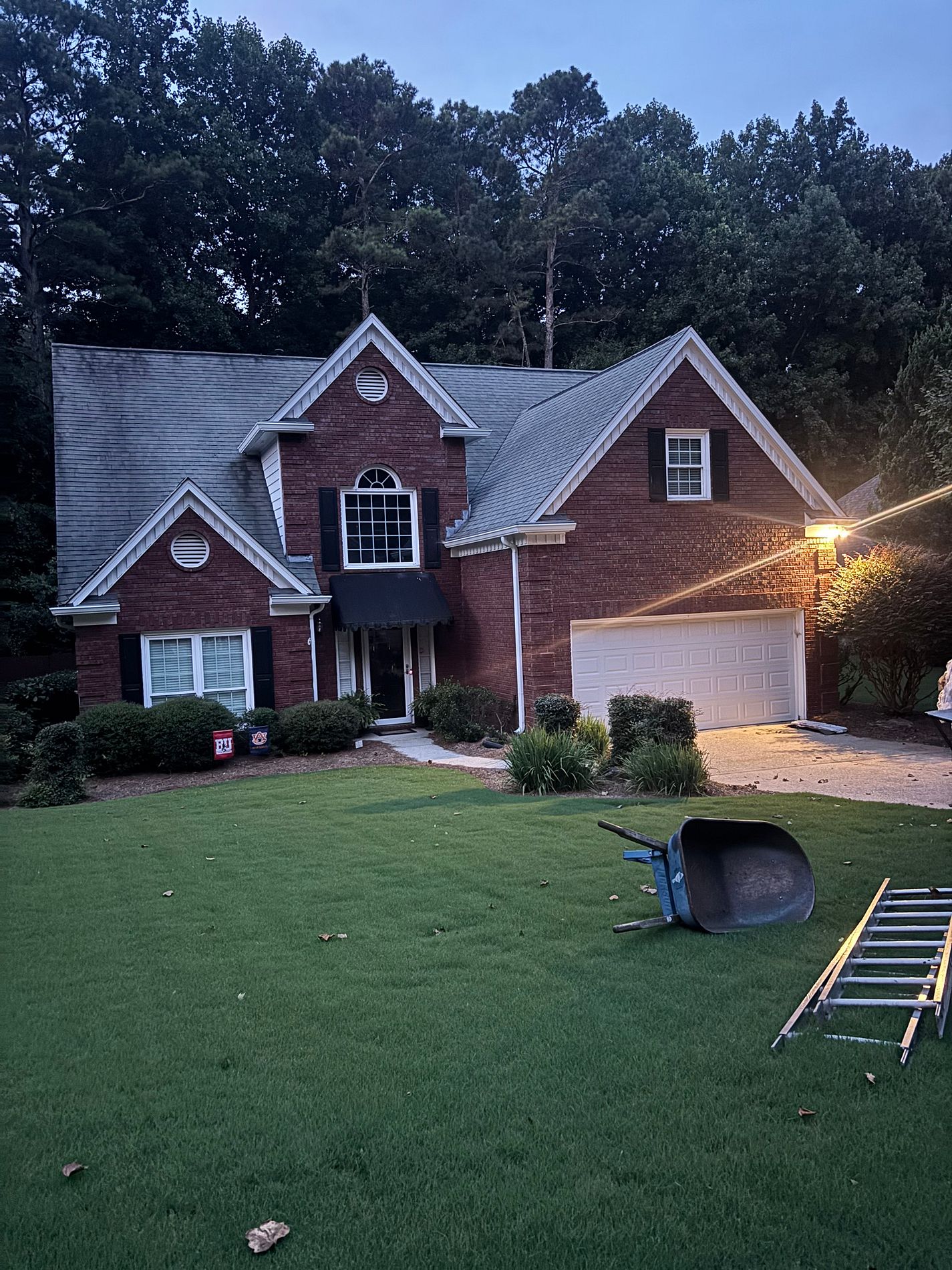 Finished Alpharetta roof at dusk — Rustic Black TAMKO Titan XT